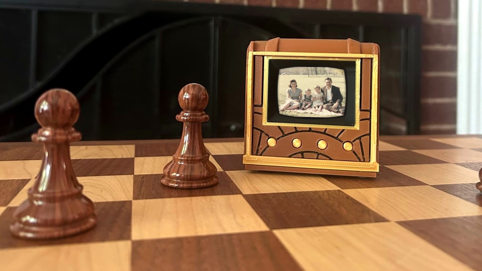 Pict-O-Vision miniature 1953-style television on a chess board, its 2-inch screen showing a family photograph